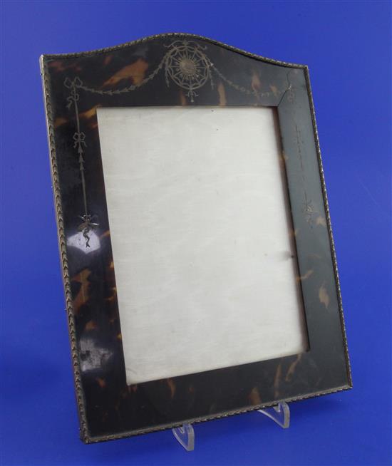 A George V tortoiseshell and silver pique mounted rectangular photograph frame, (cracked).